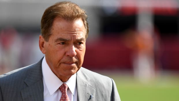 Alabama football head coach Nick Saban walks the field before a game with Texas.